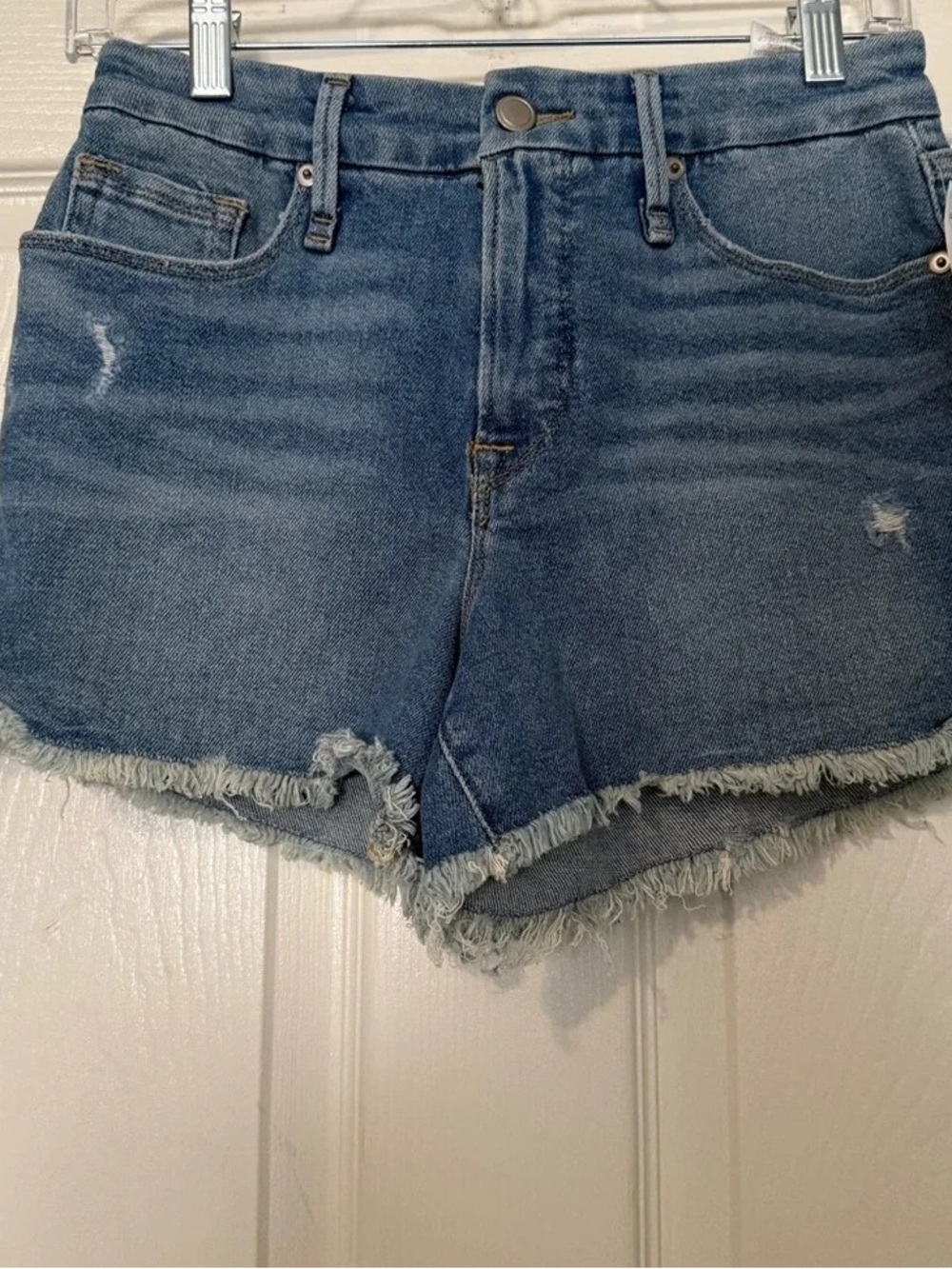 Good American Medium Blue Frayed Hem denim shorts